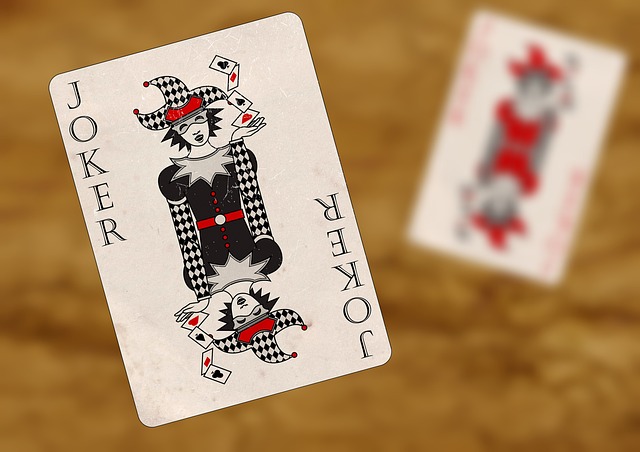 A wide shot of a black joker playing card, symbolizing strategy and unpredictability in card games.